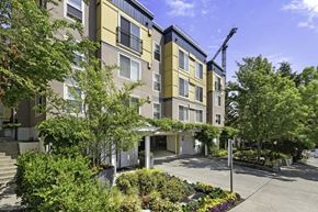 Bellevue apartment for rent - a large apartment building with a crane in the background at Sir Gallahad Apartment Homes, Bellevue, Washington 98004