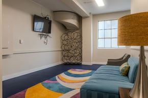 Seattle apartment for rent - A bedroom with a blue bed and a television on the wall.