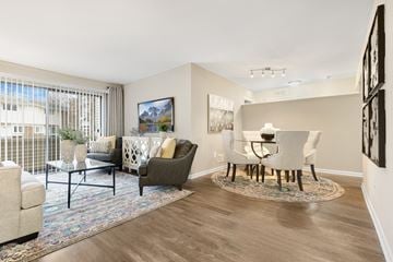 Rochester Hills apartment for rent - an open living room and dining room area with a table and chairs