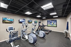 Northville apartment for rent - A gym with a row of exercise bikes and treadmills at MainCentre, Northville