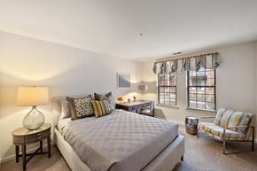 Northville apartment for rent - A bedroom with a large bed and a chair at MainCentre, Northville