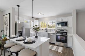 Commerce Township apartment for rent - A modern kitchen with a breakfast table set for two at Briarcliff Village, Michigan, 48390
