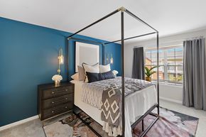Commerce Township apartment for rent - A bedroom with a four poster bed and a dresser at Briarcliff Village, Michigan, 48390