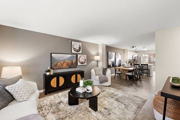 Novi apartment for rent - A living room with a grey couch, a coffee table, and a painting on the wall.