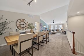 West Bloomfield apartment for rent - A dining room with a large wooden table and chairs.