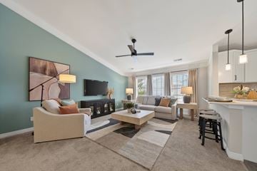 West Bloomfield apartment for rent - A living room with a couch, a chair, a coffee table, and a painting on the wall.