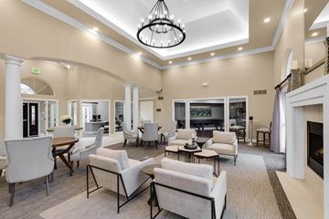 Novi apartment for rent - a large living room with couches and chairs and a fireplace