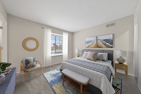 Novi apartment for rent - A bedroom with a large bed and a view of the beach.