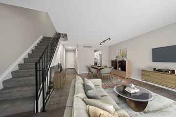 Novi apartment for rent - A living room with a grey couch and a coffee table.