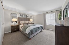 Novi apartment for rent - A bedroom with a large bed and a mirror on the wall.