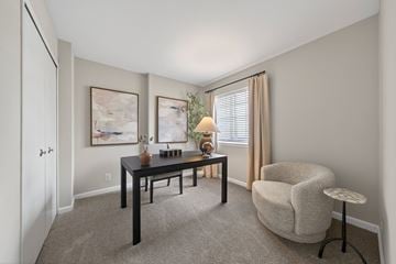 Novi apartment for rent - A living room with a table, chairs, and two paintings on the wall.