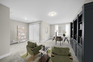 West Bloomfield apartment for rent - A living room with a green chair and a wooden table.