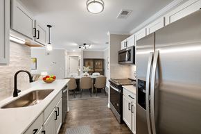 Rochester Hills apartment for rent - a kitchen and dining room with stainless steel appliances and a sink at Cidermill Village, MI