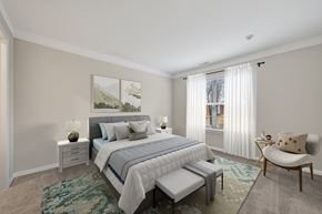 Canton apartment for rent - A bedroom with a large bed and a painting on the wall.