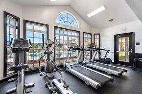 Spring Lake apartment for rent - A gym with treadmills, elliptical machines, and stationary bikes. at Village on the Lake Apartments, Spring Lake, NC, 28390