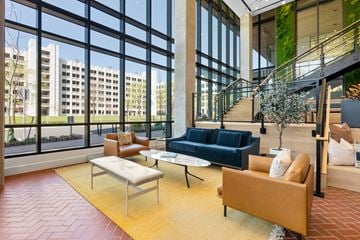 Herndon apartment for rent - a living room with couches and chairs in front of large windows