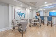 Woodbridge apartment for rent - A room with a painting of a bull and a TV on the wall.