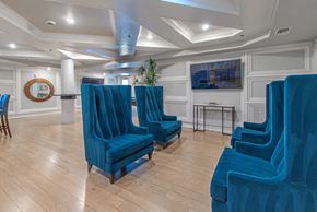 Woodbridge apartment for rent - A room with blue chairs and wooden floors.