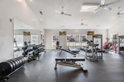 Spring Lake apartment for rent - A spacious gym with a variety of equipment including weights and cardio machines. at Stone Gate Apartments, Apartments, Spring Lake, NC