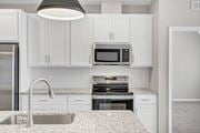 Columbia apartment for rent - A kitchen with white cabinets and a granite countertop.