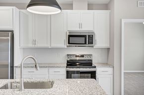 Columbia apartment for rent - A kitchen with white cabinets and a granite countertop.