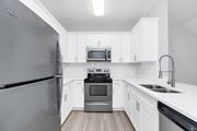 Orlando apartment for rent - a kitchen with white cabinets and stainless steel appliances at Northlake Park, Orlando, 32827