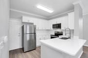 Orlando apartment for rent - a kitchen with white cabinets and stainless steel appliances at Northlake Park, Florida,32827