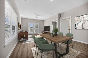 Columbia apartment for rent - A dining room with a wooden table and green chairs.