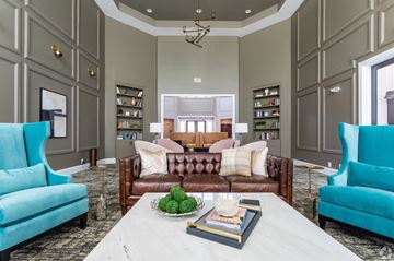 Raleigh apartment for rent - A living room with a white coffee table and a brown couch.