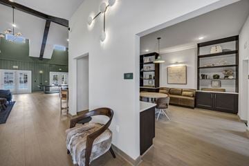 Columbia apartment for rent - A modern living room with a wooden chair and a white sofa.