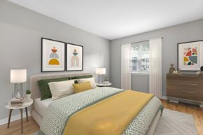 Burlington apartment for rent - a bedroom with a bed and pictures on the wall at West Pointe Apartments, Burlington