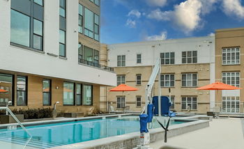 Pool and a large building with umbrellas