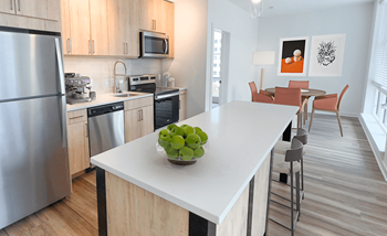 A kitchen with stainless steel appliances and a white counter top