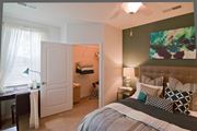 Woodbridge apartment for rent - A bedroom with a large bed and a painting on the wall. at Kensington Place Apartments, Woodbridge, VA