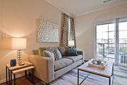 Woodbridge apartment for rent - A living room with a couch, a table, and a lamp. at Kensington Place Apartments, Woodbridge, 22191
