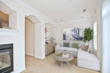 Ashburn apartment for rent - A living room with a fireplace and a painting on the wall.