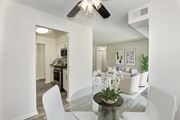 Fairfax apartment for rent - A modern dining room with a glass table and white chairs at Fairfax Square Apartments, Apartments, Fairfax, VA