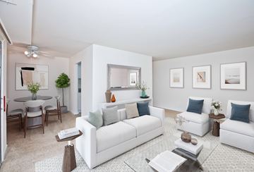 Fairfax apartment for rent - A living room with white furniture and a glass coffee table.