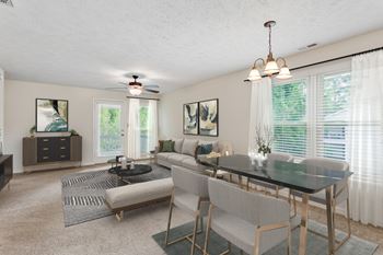 A dining room with a black table and chairs.