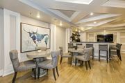 Woodbridge apartment for rent - A dining room with a table and chairs and a painting of a bull on the wall. at Kensington Place Apartments, Woodbridge, 22191