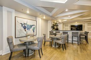 Woodbridge apartment for rent - A dining room with a table and chairs and a painting of a bull on the wall. at Kensington Place Apartments, Woodbridge, 22191