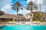 Orlando apartment for rent - A large house with a pool in front of it.