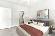 Fayetteville apartment for rent - A bedroom with a large bed and a painting on the wall at The Villagio Apartments, Fayetteville, North Carolina