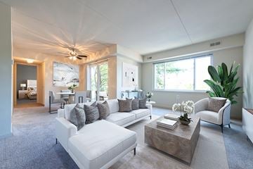 Leesburg apartment for rent - A living room with a white couch and a wooden coffee table.