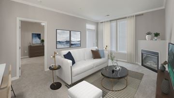 Herndon apartment for rent - A living room with a white couch and a painting on the wall.