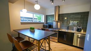 Chicago apartment for rent - a kitchen with a dining table and a stove and a window