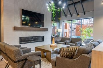 Arlington Heights apartment for rent - A living room with a fireplace and a television mounted above it.