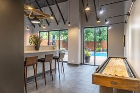 Arlington Heights apartment for rent - Entertainment space with shuffleboard and patio access at Dunton Tower Apartments, Arlington Heights, IL