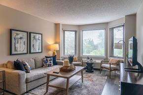 Naperville apartment for rent - A living room with a couch, a coffee table, and a television.