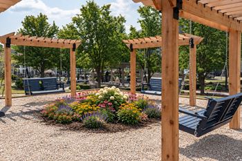 Outdoor garden area with pergola and hanging swings